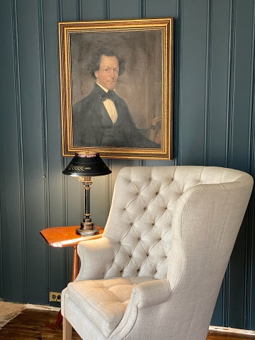 White chair with picture and blue wall